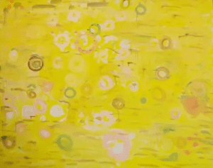 A yellow painting with white and pink circles.